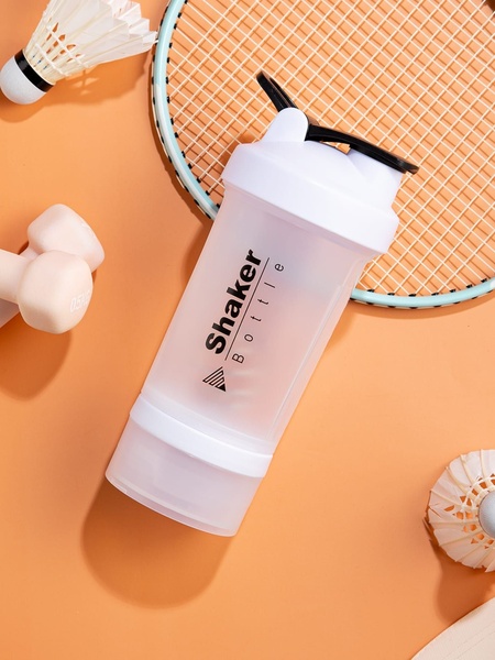 A top-down, clean product-focused shot of a Shaker Bottle surrounded by workout equipment on a warm, monochromatic background.